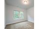 Cozy bedroom with plush carpet and large window offering natural light at 54 Northwood Dr, Fuquay Varina, NC 27526