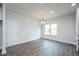 Bright dining room with modern light fixture and wood floors at 54 Northwood Dr, Fuquay Varina, NC 27526