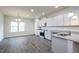 Modern kitchen with white cabinets, stainless steel appliances, and granite counters at 54 Northwood Dr, Fuquay Varina, NC 27526