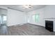 Living area with fireplace, ceiling fan, and access to the outdoors at 54 Northwood Dr, Fuquay Varina, NC 27526