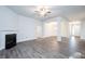 Open-concept living room with fireplace, columns, and view to the dining area at 54 Northwood Dr, Fuquay Varina, NC 27526