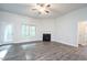 Bright living room with a fireplace, ceiling fan, and wood-look flooring at 54 Northwood Dr, Fuquay Varina, NC 27526