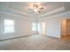Large main bedroom with plush carpet, tray ceiling, and ceiling fan at 54 Northwood Dr, Fuquay Varina, NC 27526