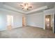 Spacious main bedroom with carpet, tray ceiling, and ceiling fan at 54 Northwood Dr, Fuquay Varina, NC 27526