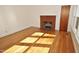 Bright living room with hardwood floors and a brick fireplace at 659 Loop Rd, Burlington, NC 27217