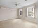 Bright bedroom featuring carpet and two windows at 6601 Graymont Pl, Raleigh, NC 27615