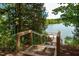 Steps leading down to a wooden dock on the lake at 1212 Holding Village Way, Wake Forest, NC 27587