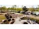 Relaxing patio area with fire pit overlooking a serene lake at 1212 Holding Village Way, Wake Forest, NC 27587