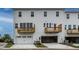 Rear view of townhomes showcasing private balconies and garages at 1212 Holding Village Way, Wake Forest, NC 27587