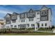 Exterior view of three-story townhomes with modern design at 1212 Holding Village Way, Wake Forest, NC 27587