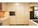 Modern kitchen with light wood cabinets and built-in appliances at 140 W Franklin St # 800, Chapel Hill, NC 27516