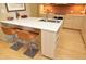 Kitchen island with seating, white countertop and built-in shelving at 140 W Franklin St # 800, Chapel Hill, NC 27516
