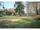 Large backyard with deck and wooded area at 5829 Sandstone Dr, Durham, NC 27713