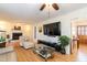 Spacious living room with hardwood floors, fireplace and large TV at 5829 Sandstone Dr, Durham, NC 27713