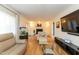 Living room with hardwood floors, fireplace, and large windows at 5829 Sandstone Dr, Durham, NC 27713