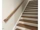 Modern staircase with wood treads and a simple handrail at 7822 Berry Crest Ave, Raleigh, NC 27617