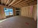 Unfinished bedroom with large window and wood framing at 8 Steppe Way, Garner, NC 27529