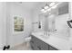 Modern bathroom with gray vanity, white subway tile, and hexagon floor tile at 2503 Lednum St, Durham, NC 27704