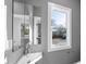 Modern bathroom with corner sink, white vanity, and large window at 2503 Lednum St, Durham, NC 27704