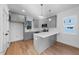 Modern kitchen with gray cabinets, quartz countertops, and stainless steel appliances at 2503 Lednum St, Durham, NC 27704