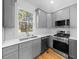 Modern kitchen features gray cabinets, stainless steel appliances, and white quartz countertops at 2503 Lednum St, Durham, NC 27704