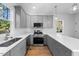 Modern kitchen with gray shaker cabinets and stainless steel appliances at 2503 Lednum St, Durham, NC 27704