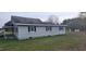 Side view of a single-story home with white siding and black shutters at 332 Bass Lake Road Rd, Holly Springs, NC 27540