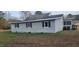 Rear exterior view of a single-story house with a screened porch at 332 Bass Lake Road Rd, Holly Springs, NC 27540
