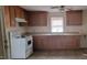 Simple kitchen with wooden cabinets, white appliances, and tile flooring at 332 Bass Lake Road Rd, Holly Springs, NC 27540