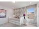 Charming bedroom with a daybed, side table, and geometric patterned wall at 508 Hester Rd, Durham, NC 27703