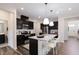 Modern kitchen with dark cabinets, granite countertops and island with seating at 508 Hester Rd, Durham, NC 27703
