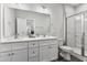 Bathroom features a double vanity, white cabinets, and a shower at 5711 Piney Grove Rd, Angier, NC 27501