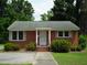 Brick ranch house with a landscaped lawn and walkway at 608 N Ellis Ave, Dunn, NC 28334