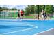 Outdoor basketball court with blue surface and white lines; great for recreation at 83 Meath Ct # 209, Clayton, NC 27520