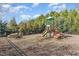 playground with playset, slides, and picnic table in a fenced area at 83 Meath Ct # 209, Clayton, NC 27520