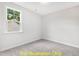 Bright bedroom with carpeted floor and a window overlooking the backyard at 117 Deer Cross Dr, Louisburg, NC 27549