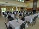 Large community room with tables and chairs, perfect for events at 117 Deer Cross Dr, Louisburg, NC 27549