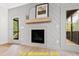 Gathering room with fireplace, built-in shelving, and access to deck at 117 Deer Cross Dr, Louisburg, NC 27549