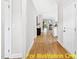 Light-filled hallway with wood flooring, leading to the living areas at 117 Deer Cross Dr, Louisburg, NC 27549