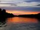 Peaceful sunset view over the calm lake waters at 117 Deer Cross Dr, Louisburg, NC 27549