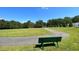 Curved walking path with bench overlooking green space at 117 Deer Cross Dr, Louisburg, NC 27549