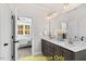 Modern bathroom with double vanity and view into bedroom at 212 Rawhide Dr, Louisburg, NC 27549