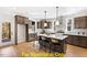 Spacious kitchen with an island, dark wood cabinets, and white quartz countertops at 212 Rawhide Dr, Louisburg, NC 27549