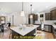 Modern kitchen with island, stainless steel appliances, and white subway tile backsplash at 212 Rawhide Dr, Louisburg, NC 27549