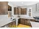 Kitchen with corner sink, dark wood cabinets, and white quartz countertops at 212 Rawhide Dr, Louisburg, NC 27549