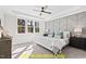 Spacious main bedroom with a geometric accent wall and large windows at 212 Rawhide Dr, Louisburg, NC 27549