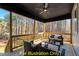 Relaxing screened porch with wicker furniture and ceiling fan at 212 Rawhide Dr, Louisburg, NC 27549