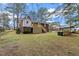 View of the home's backyard with a deck at 303 Forest Rd, Oxford, NC 27565
