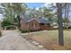 Brick ranch house with a large yard and a spacious deck at 303 Forest Rd, Oxford, NC 27565