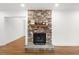 Stone fireplace with a wood mantel in the living room at 303 Forest Rd, Oxford, NC 27565